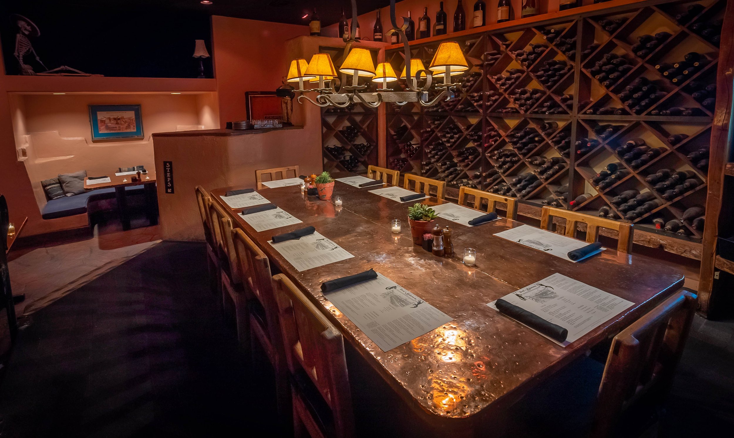 Candlelit copper table and wine wall in Dick’s Hideaway’s private dining room